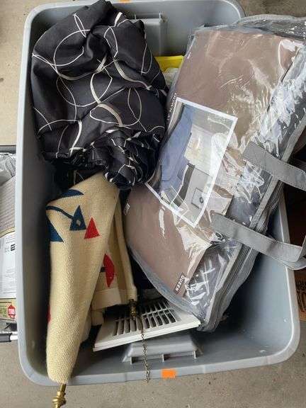 Tote with miscellaneous home items. Comforter, curtains, etc.. ￼ image