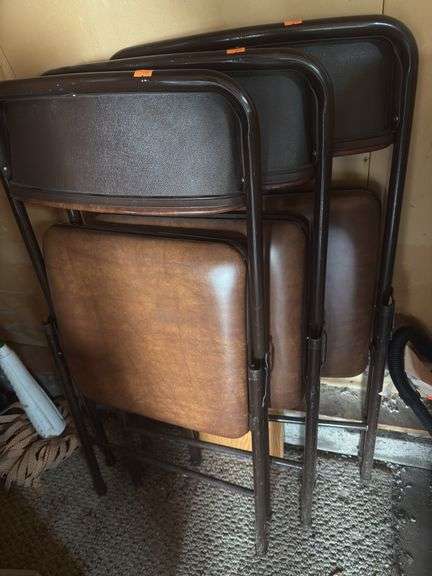 Three metal folding chairs image