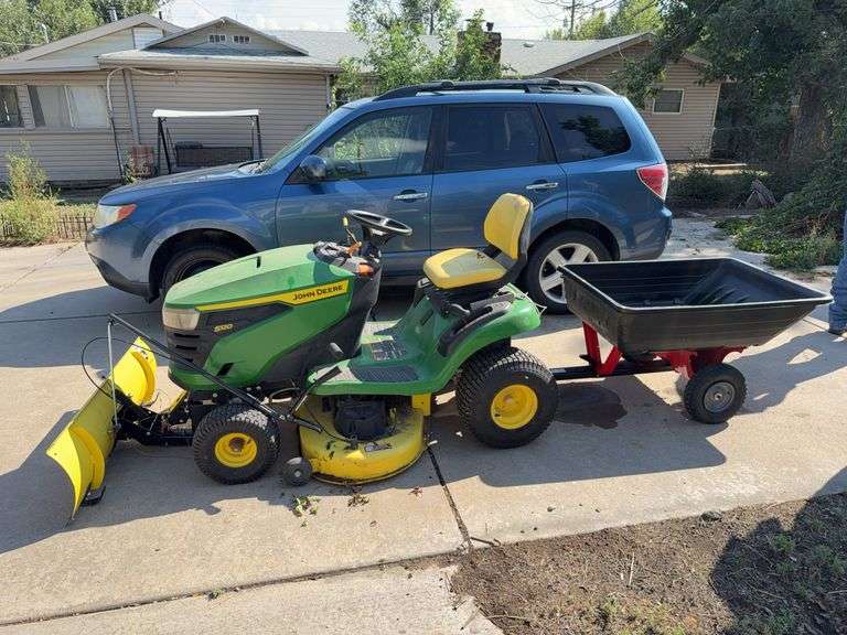 John Deere S120 lawn tractor with mowing deck, utility trailer and snow blade. Does run was tested. image
