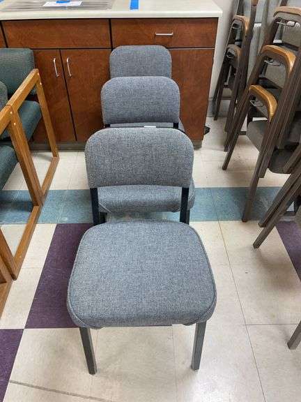 Lot of three chairs. black metal with gray upholstered cushions image