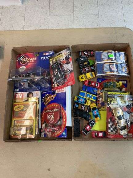 ￼Two boxes of NASCAR diecast cars and collectibles image