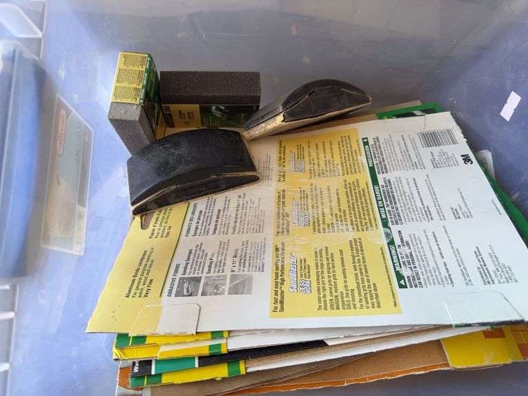 Plastic tub with 3 inch sandpaper and hand sanding bricks image