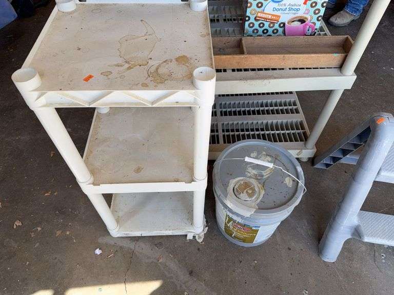Plastic shelf and 5 gallons of paint image
