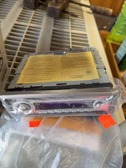 Kenwood stereo deck for car in packaging with manual and remote image