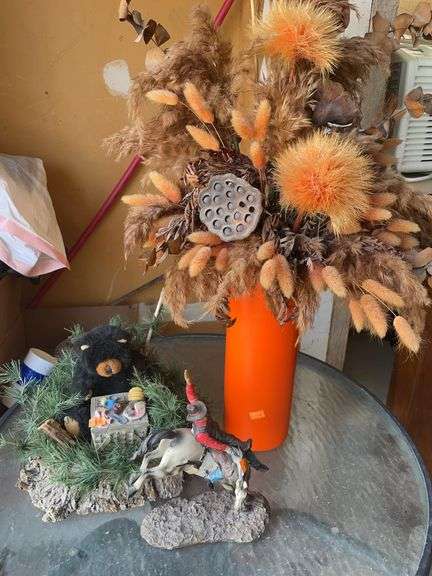 Miscellaneous home decor. Cowboy statue, bear decoration, and vase. image