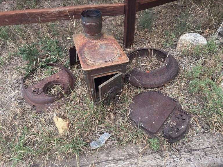 Assorted cast iron stove parts, yard art image