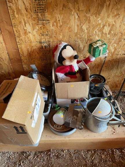 Lot of miscellaneous. Water can, planters, Christmas Mickey Mouse, plastic containers, and a clock. image