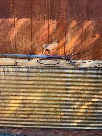 Metal elk cut out rack and antique pitchfork image