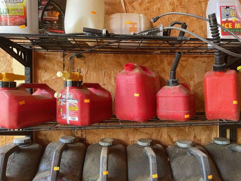 Five small gas cans w/ some gas image
