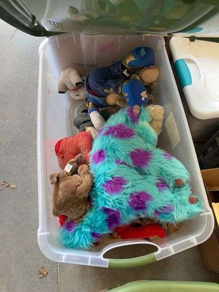 Plastic tote with an assortment of stuffed animals image