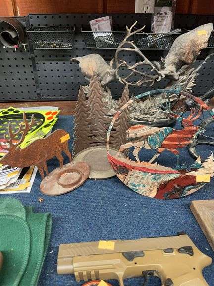 Two metal elk cut outs and a metal tree candle holder image
