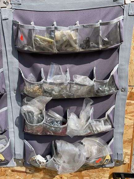 Soft storage bins containing screws, brackets, drywall anchors, etc. image