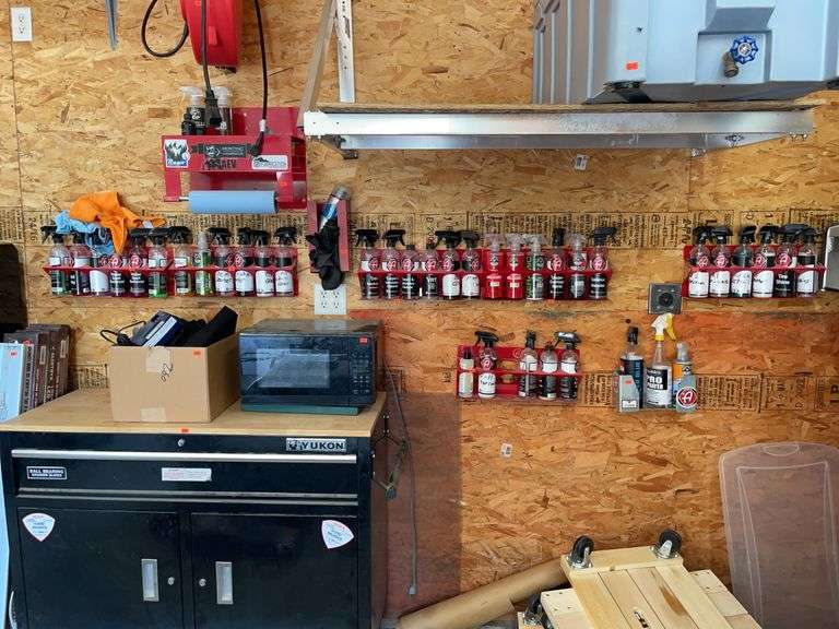 Large assortment of automotive detailing chemicals and metal racks image