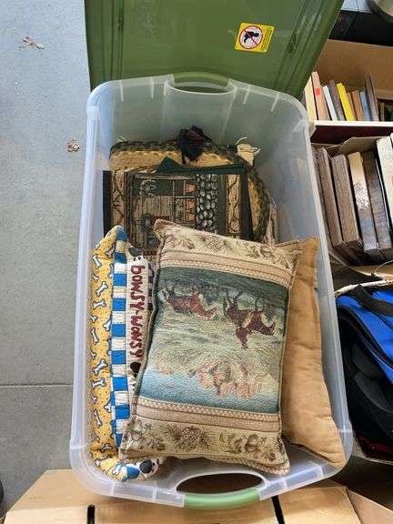 Plastic tote with an assortment of pillows, table, runners, and placemats image