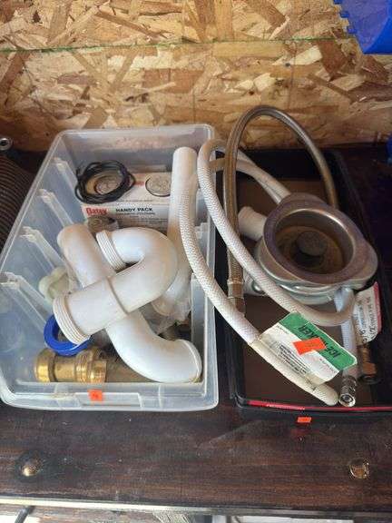 Assorted plumbing, fixtures, sink, P traps, assorted shark bites and PVC glue kit, stainless braided hose kit, and sinker drain kit image
