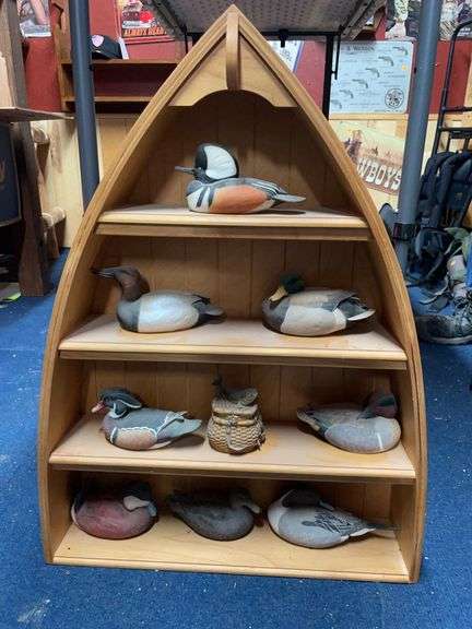Wooden canoe shelf with North American ducks decoy collection by George Kruth. image