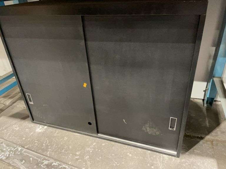 Black metal cabinet with one shelf image