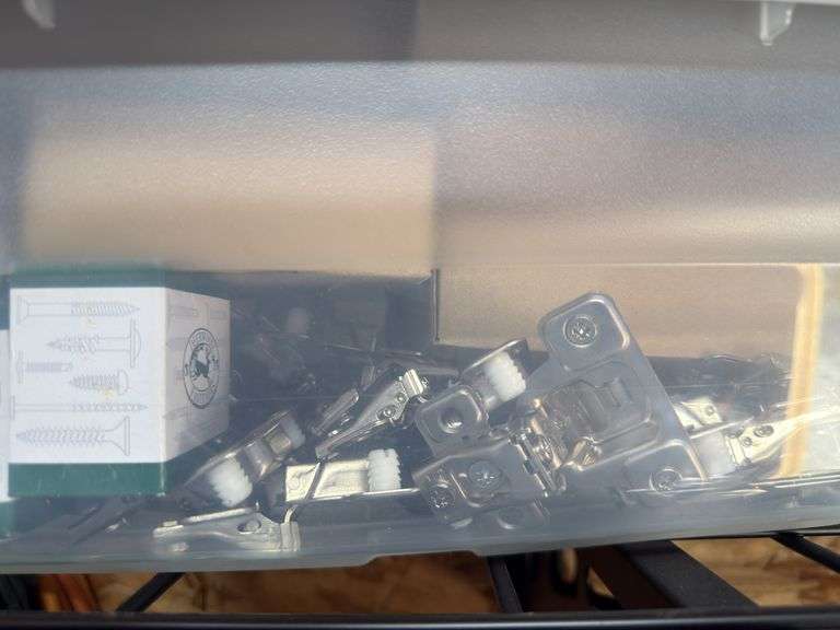 Container of cabinet making hardware, hinges, mounting screws, brackets image