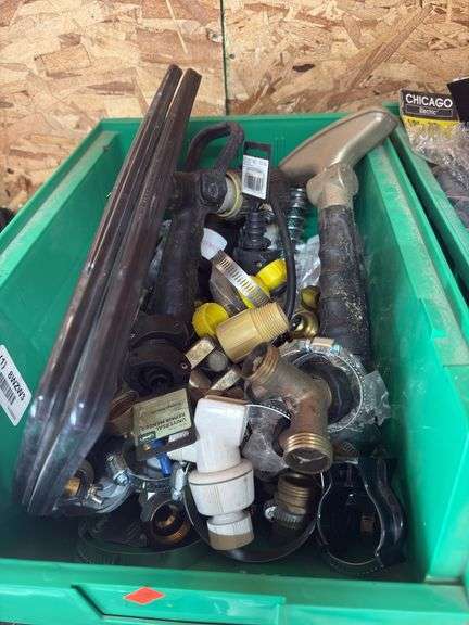 Assorted hose fittings hose clamps sprinkler heads with green bin image