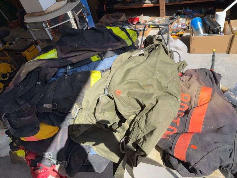 Table full of turnout gear jackets pants gloves image