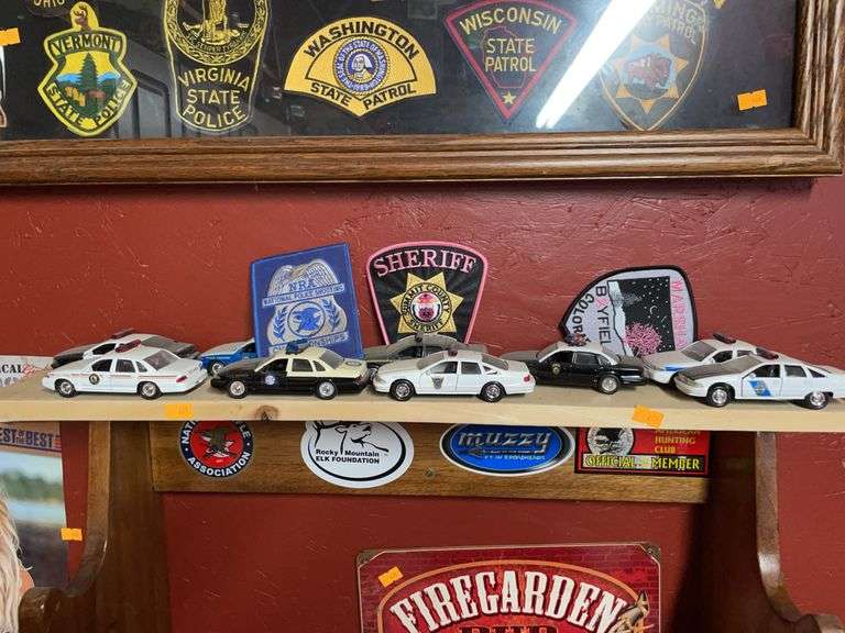 Lot of nine diecast cop, cars, and three patches image
