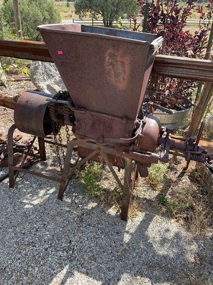 Antique grinder, yard art. image
