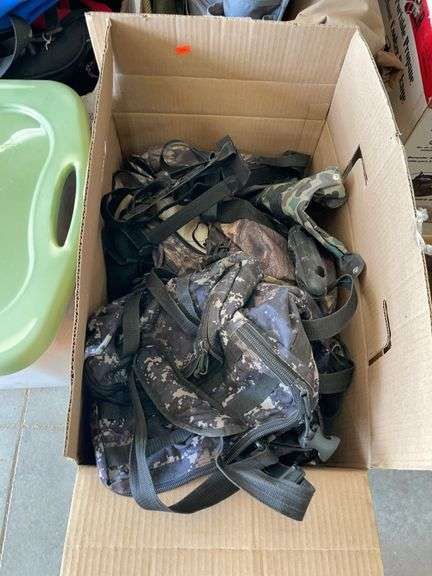 Box of assorted tactical gear and camouflage image