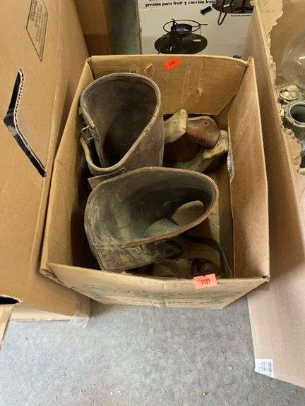 Box of vintage stirrups and leather sleeves image