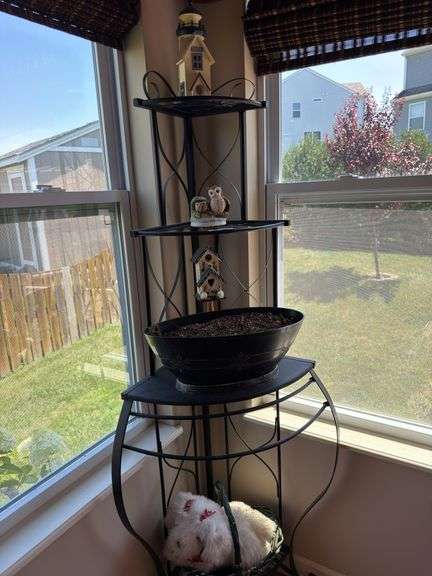 Plant stand with contents. 64” tall. Fits in corner