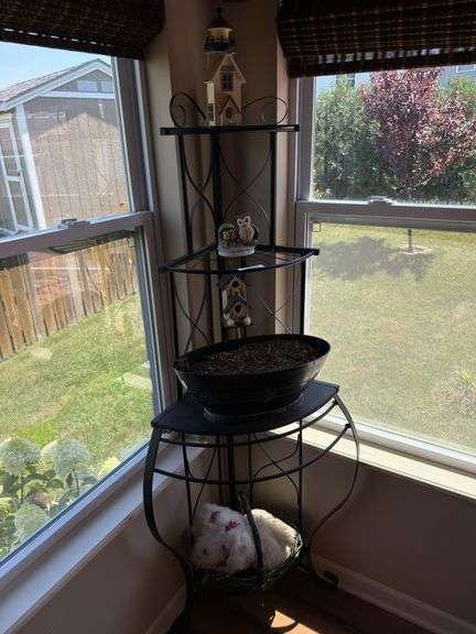 Plant stand with contents. 64” tall. Fits in corner