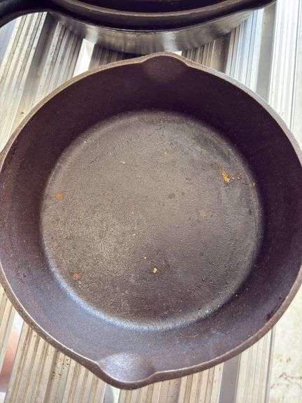 Group of cast iron skillets as shown