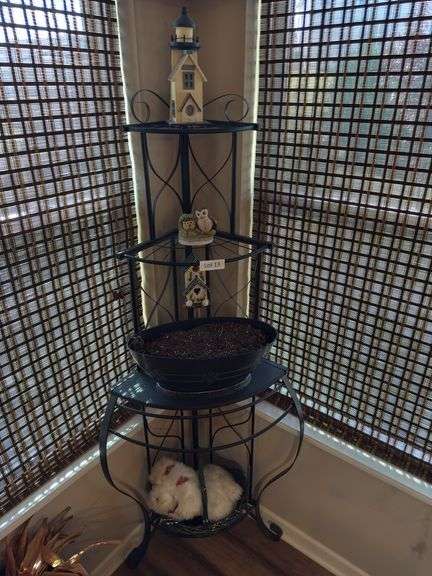 Plant stand with contents. 64” tall. Fits in corner
