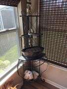 Plant stand with contents. 64” tall. Fits in corner