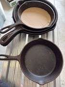 Group of cast iron skillets as shown