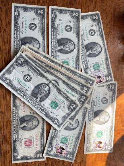 $52 face value in $2 bills. Some with stamps and one red seal