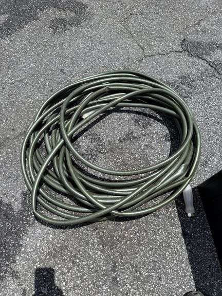 Outdoor Storage Box with Assorted Garden Hoses and Accessories