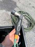 Outdoor Storage Box with Assorted Garden Hoses and Accessories