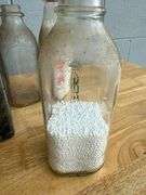 Collection of Glass Milk Bottles with Wooden Crate