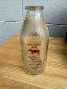 Collection of Glass Milk Bottles with Wooden Crate