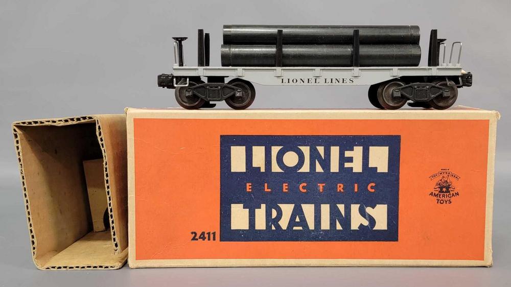 Postwar Lionel O gauge 2411 flat car with pipes in original box with insert and inspection slip