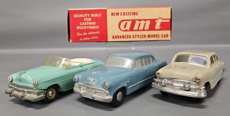 Three early promo cars with an original box image