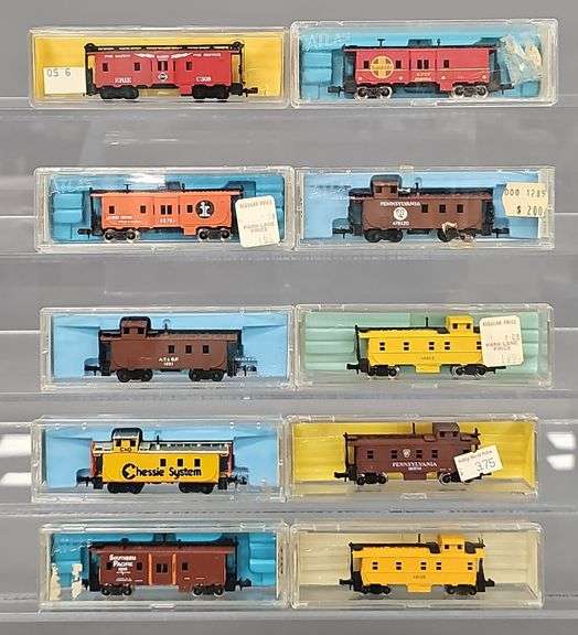 Ten Atlas N Scale Cabooses in Clear Cases
