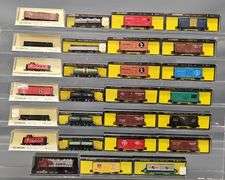 Twenty-seven Bachmann N Scale Freight Cars with one Diesel Locomotive in Clear Cases