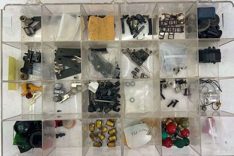 Parts bin full of Lionel parts, lamps, screws, couplers, lamp covers and MORE image
