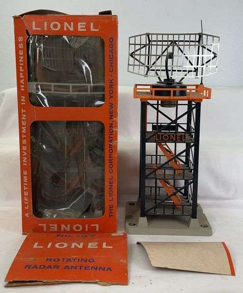 Two postwar Lionel O Gauge 197 rotating radar antenna tower variations, one in original picture window box image