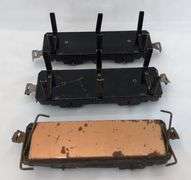 Twenty-five Marx O Gauge flat cars, pipe/log cars, chassis olive drab