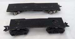 Twenty-five Marx O Gauge flat cars, pipe/log cars, chassis olive drab