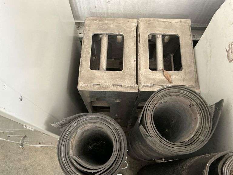 Heavy aluminum castings and rolls of rubber. image