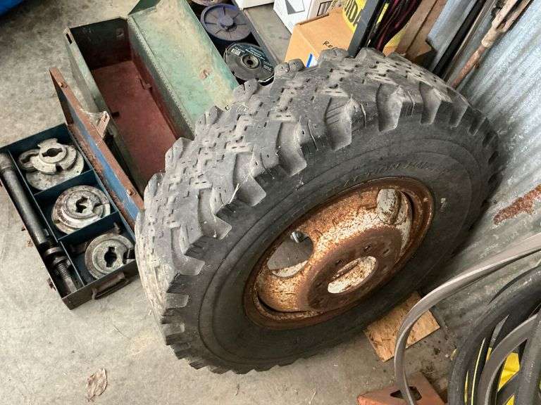 Truck Tire, Metal Tool Box with Contents, and Assorted Parts image