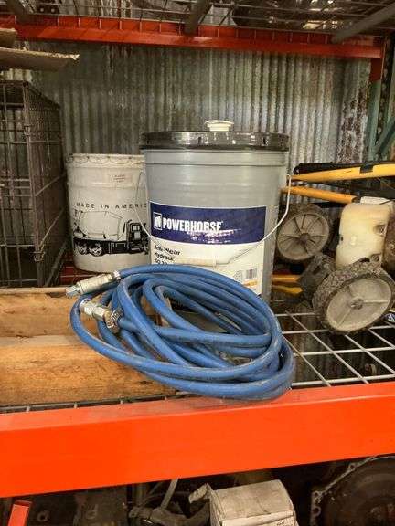 Shelf of Various Items - Coolant Reservoir, Hydraulic Fluid, Wheeled Machine